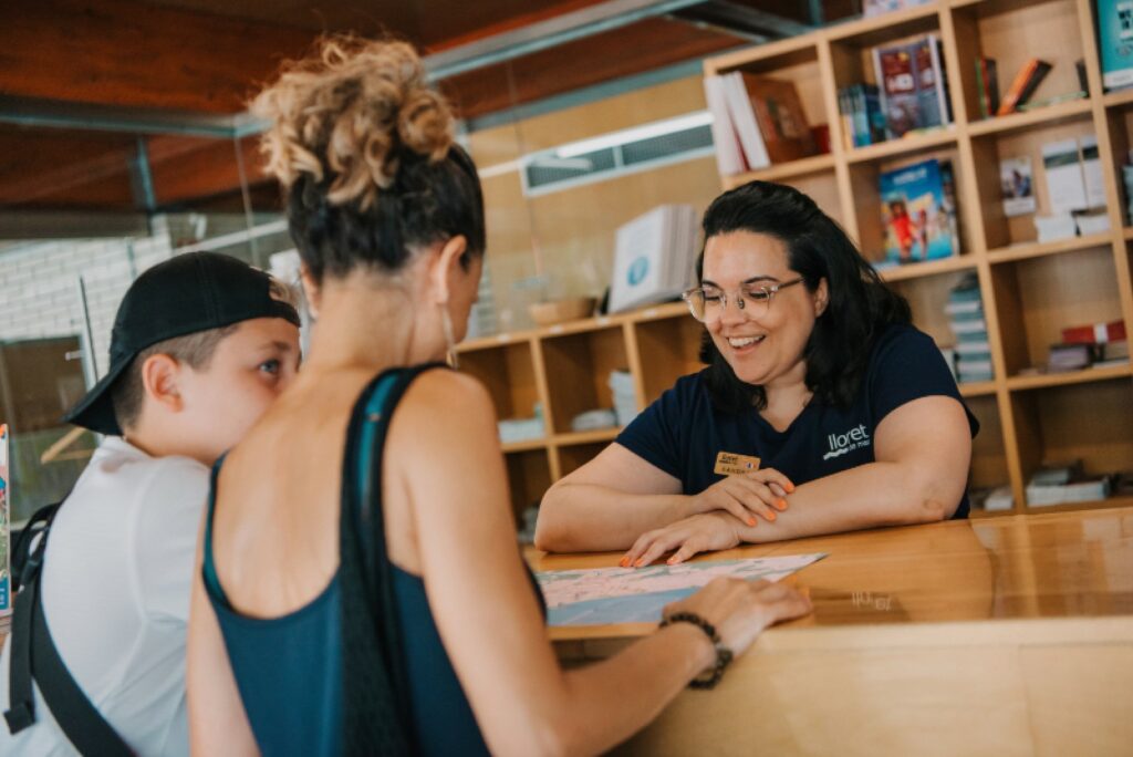 Visitants fent una consulta a l'oficina de turisme (Lloret Turisme)