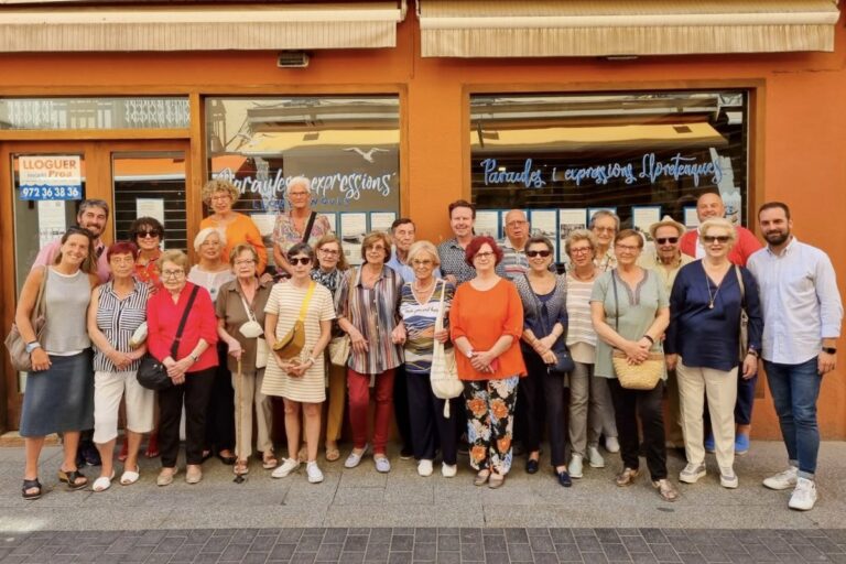 Els Amics de l'Arxiu, amb diferents representants municipals i dels comerciants, a davant de l'aparador del carrer de la Vila.